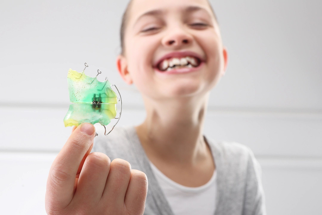 Queens Orthodontist Shows Retainer